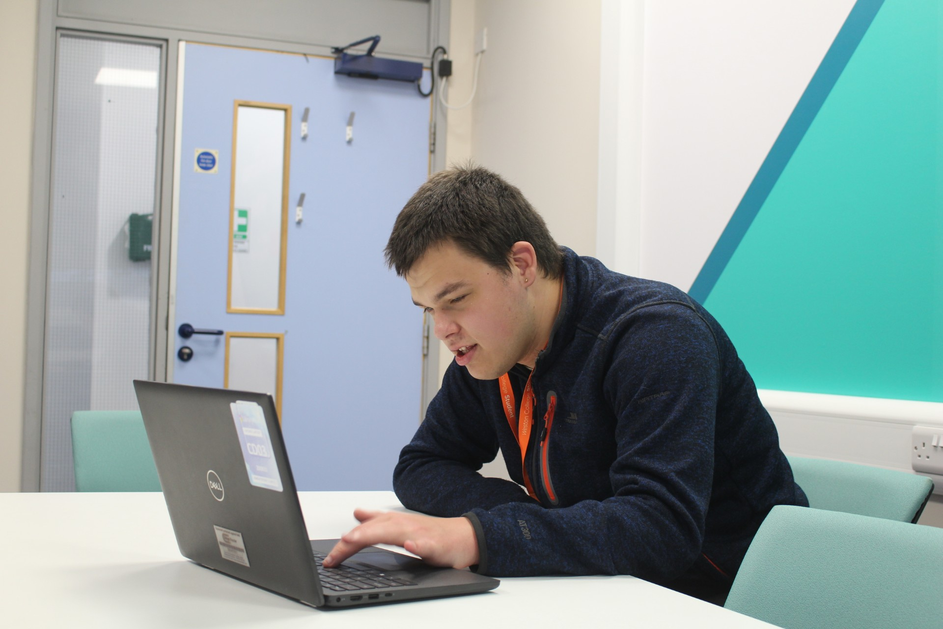 John working on a laptop