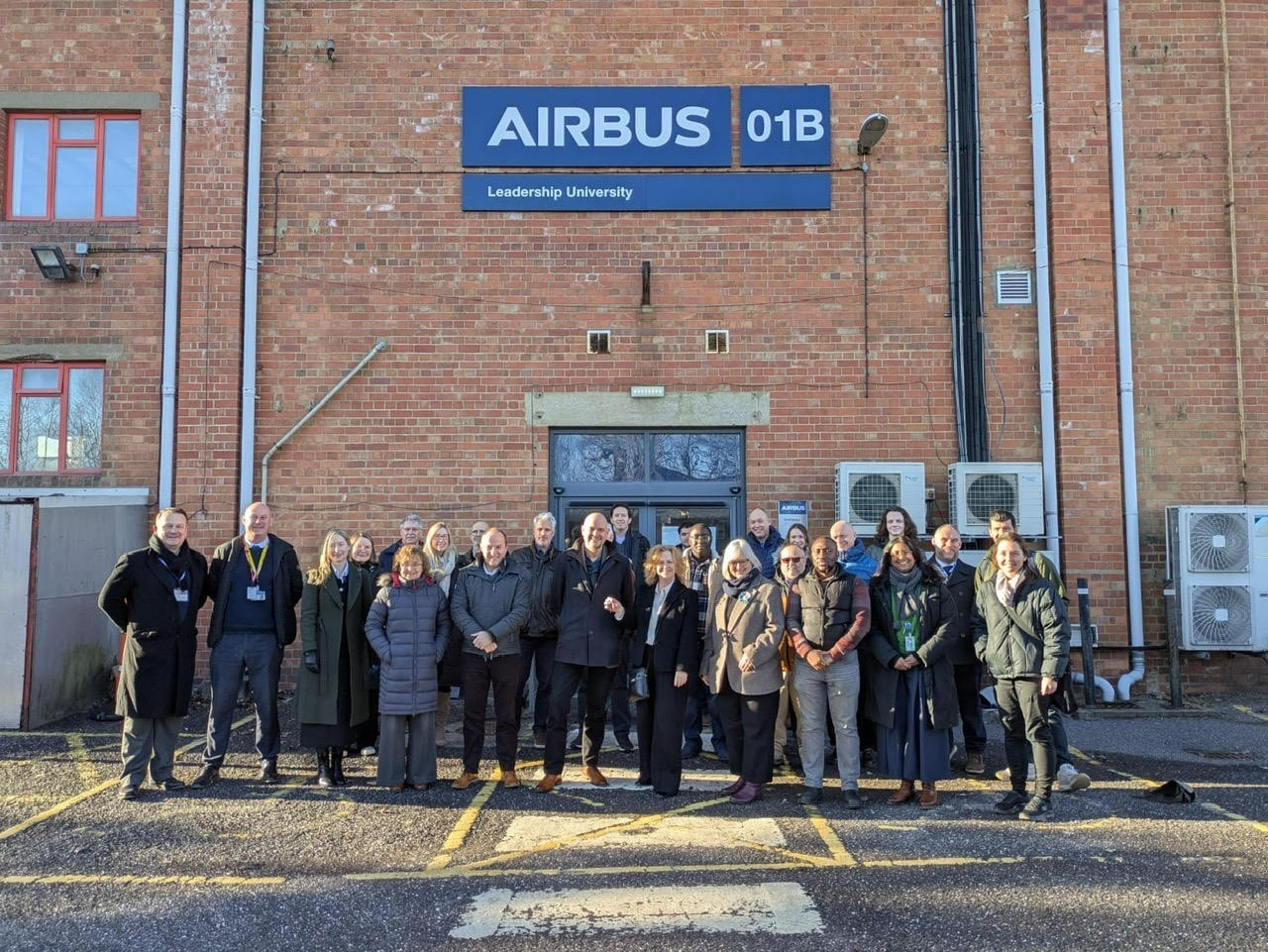 Group of Weston College and Airbus colleagues standing in front of Airbus building