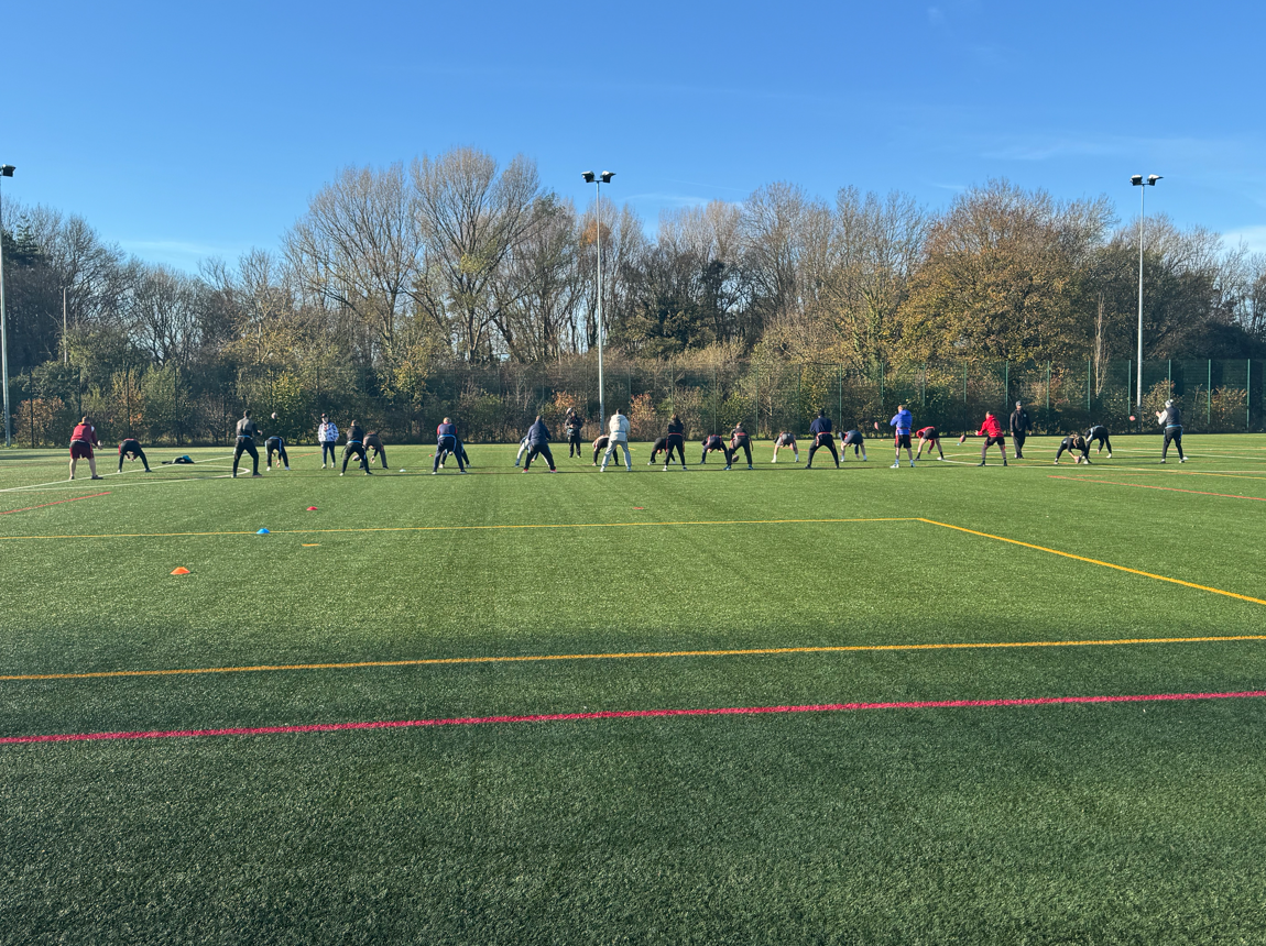 Staff waiting to catch the ball during training