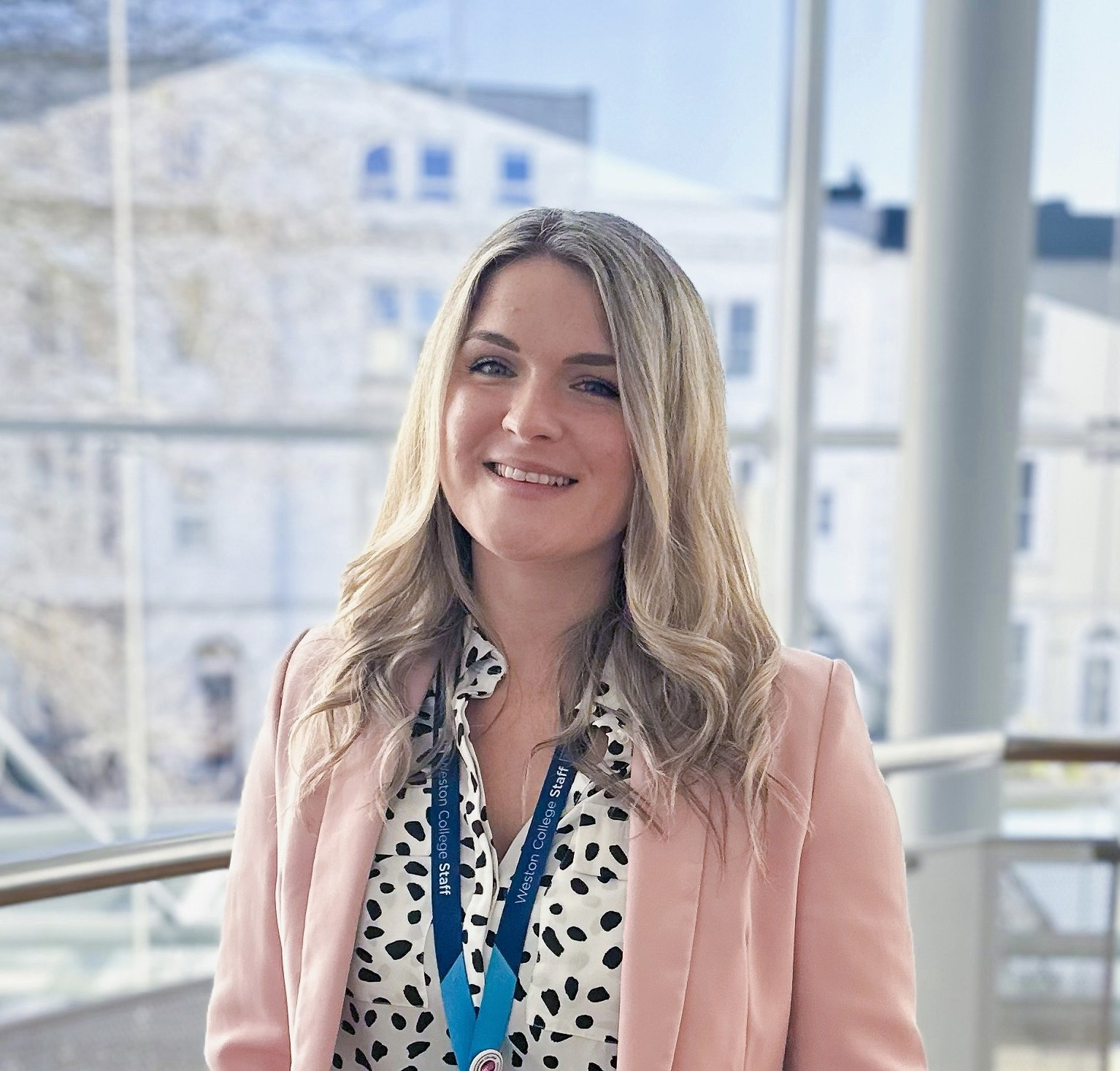 Chloe Wilde standing on balcony smiling