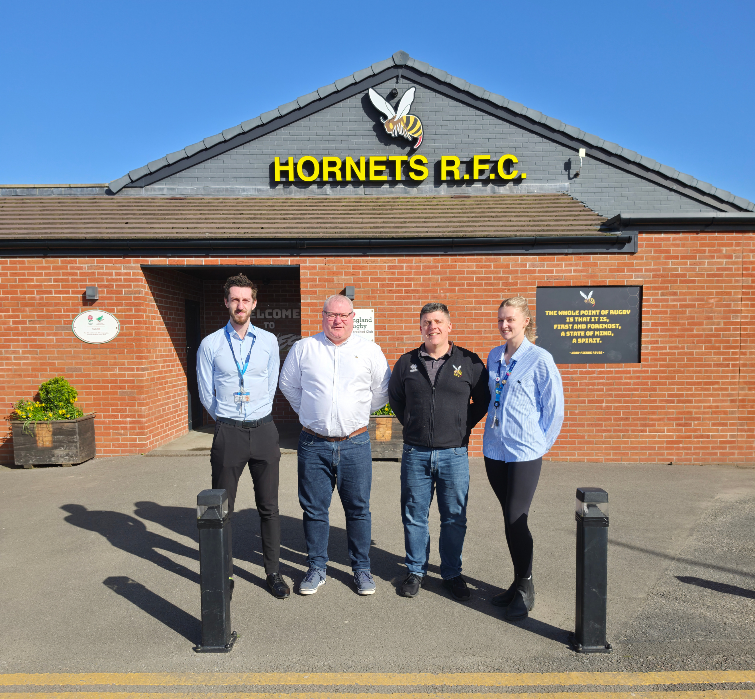 Hornets Agreement - Luke, Lee, James and Morgan standing in front of Hornets Home