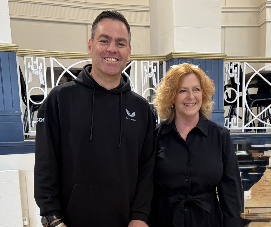 Pat Jones and Johann Van Graan posing with framed rugby shirt