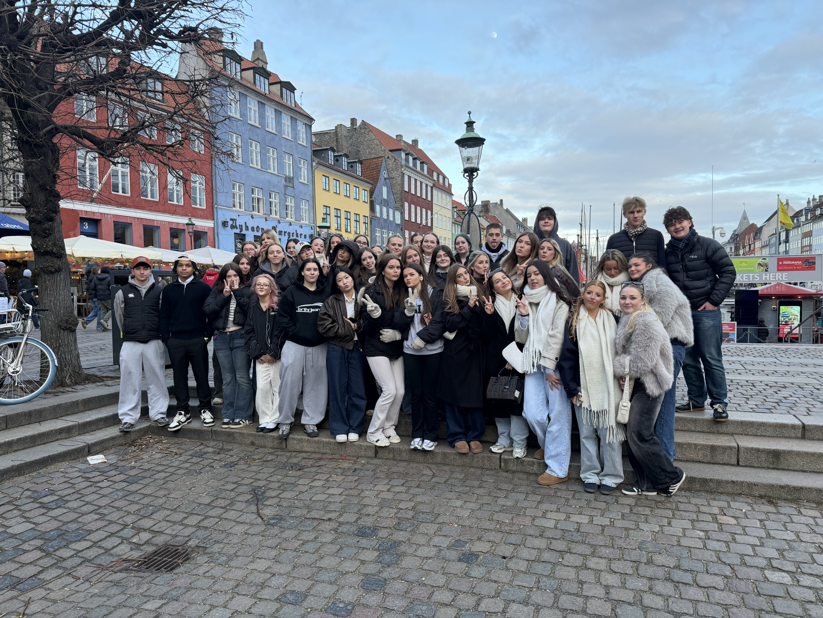 Business and Travel students standing in front of colourful buildings
