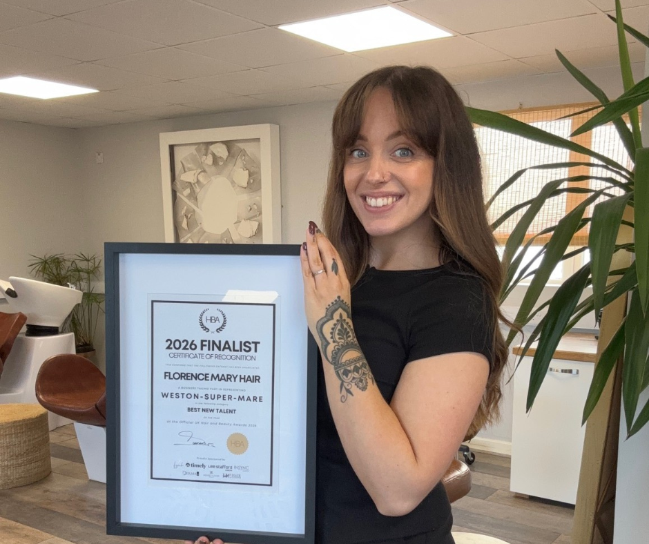 Florence in salon holding up award