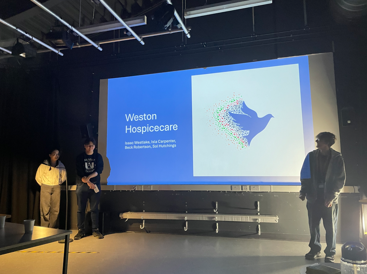 Students standing in front of their Weston Hospicecare presentation