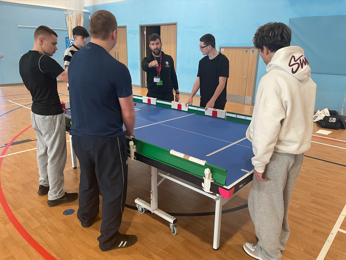 Students learning how to play table cricket
