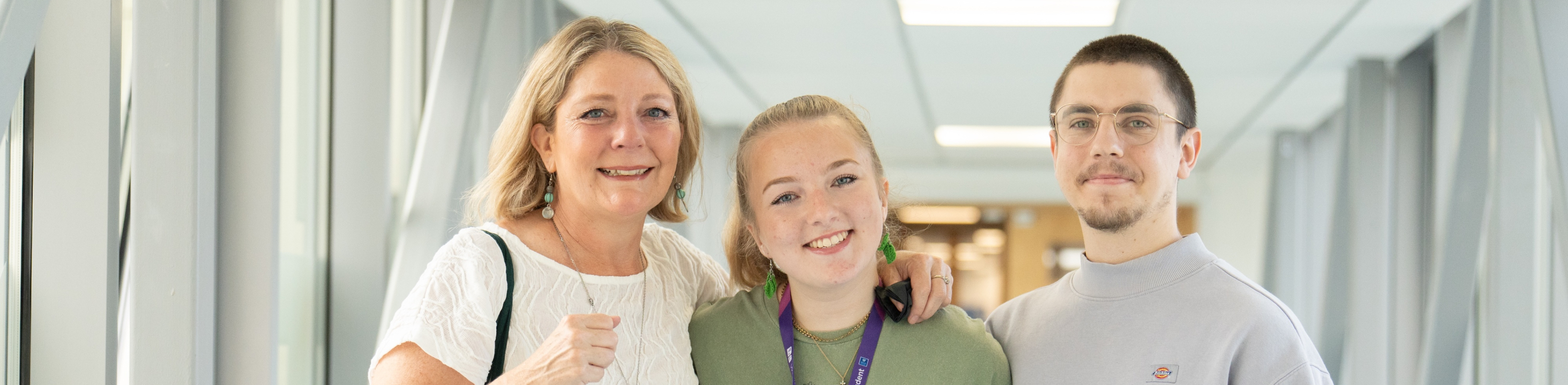 a student with her mum and brother smiling 