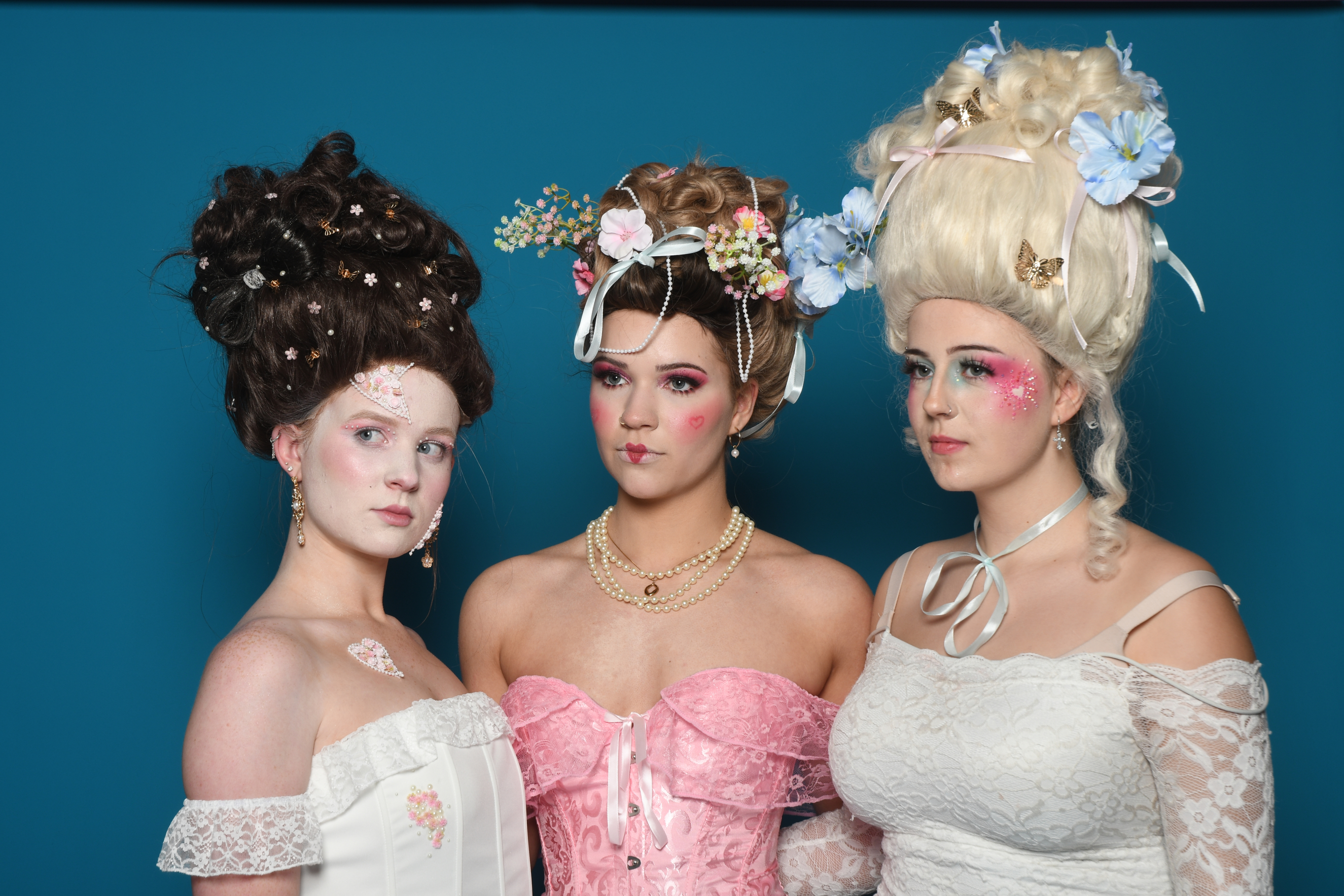 Three hair and Makeup models posing together in photoshoot
