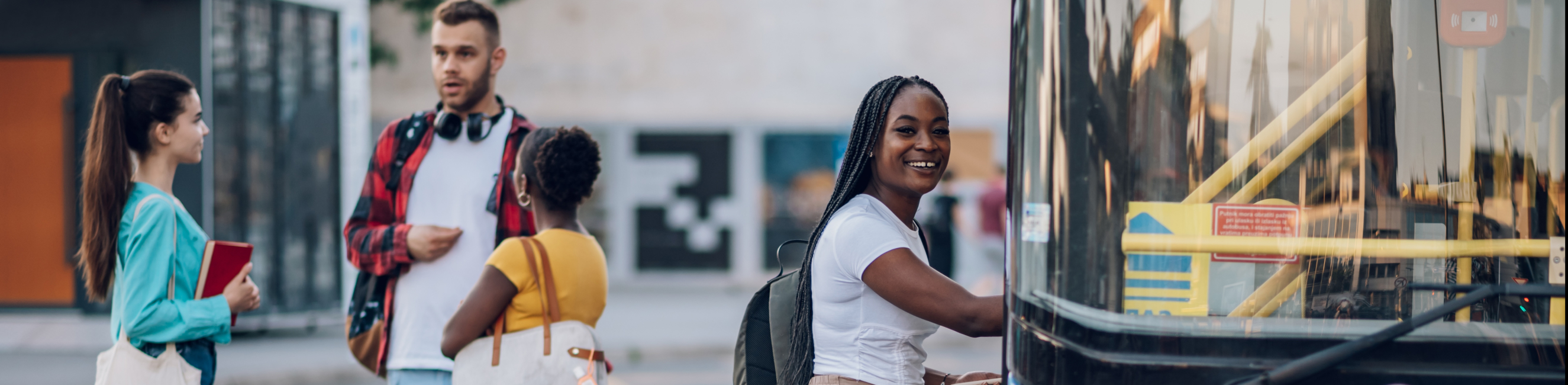 young women getting onto a bus
