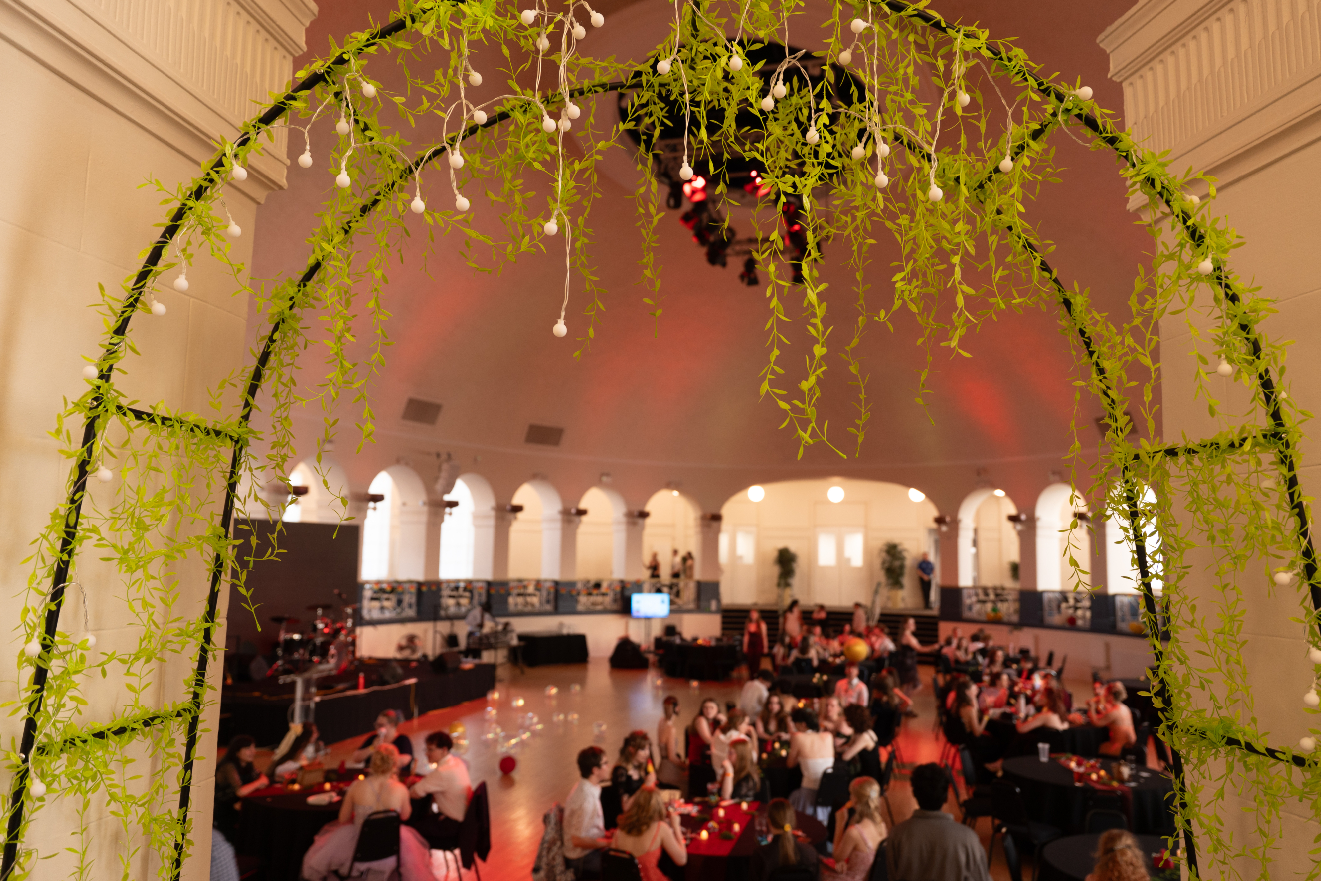 Winter Gardens entrance with greenery and students celebration in the background