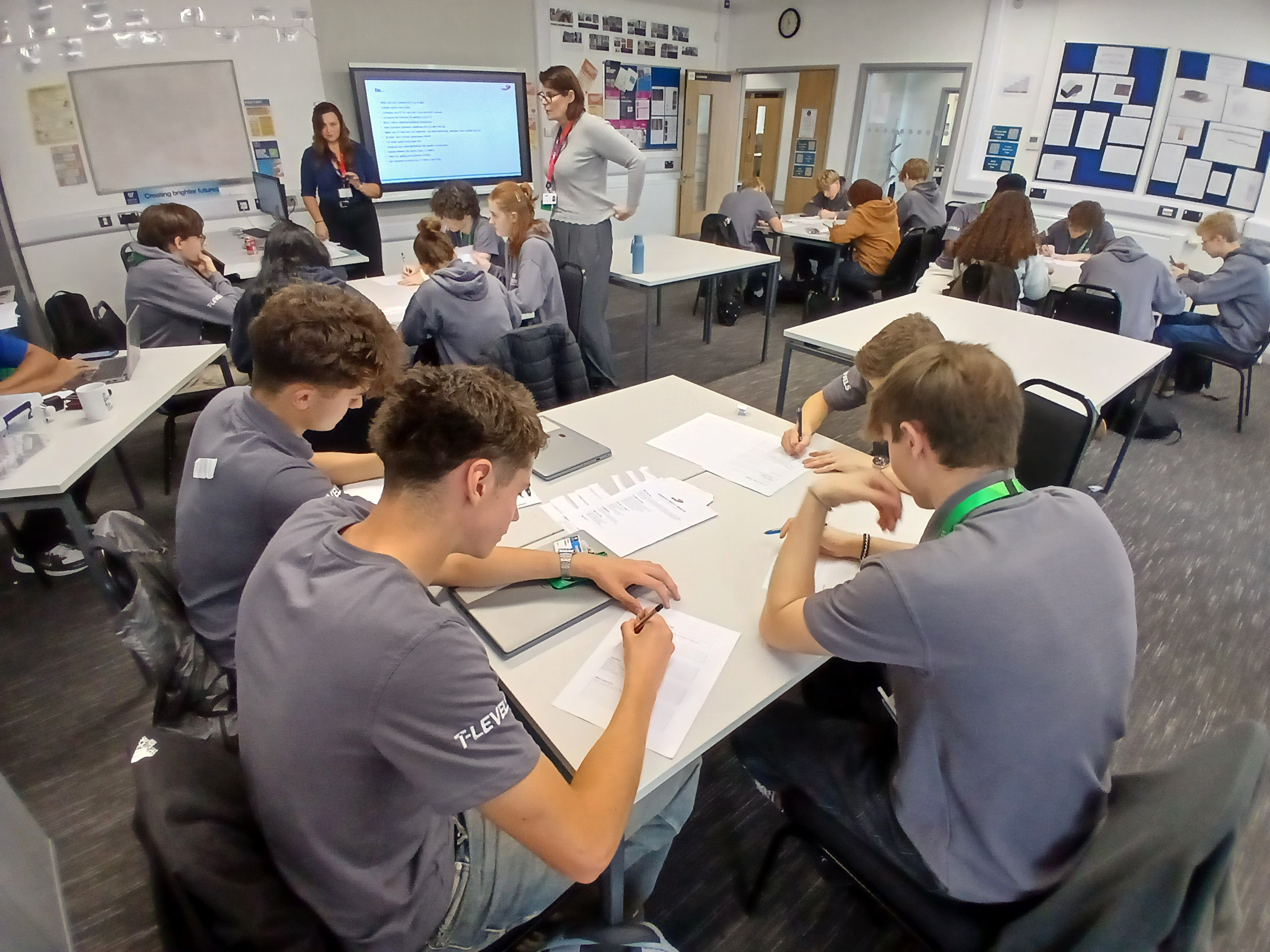 Students sat at tables while writing during CV workshop