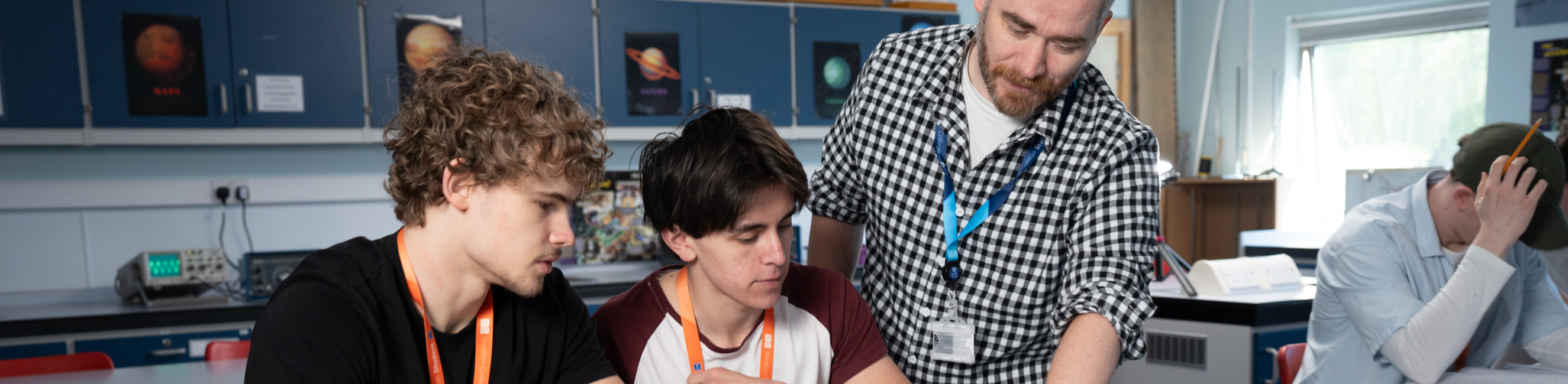 Teacher helping students with their work