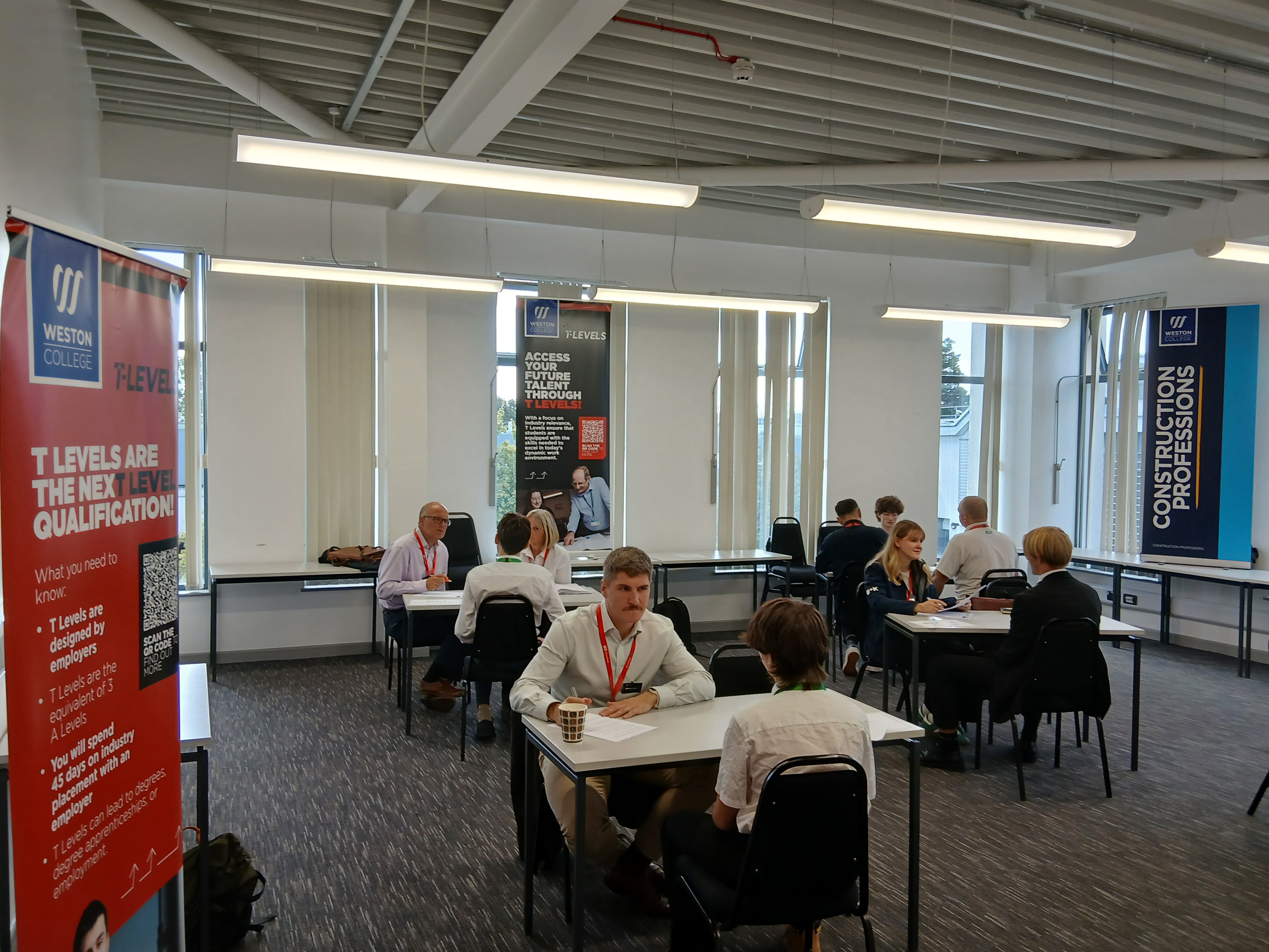 Speed interviews happening around the classroom on small tables