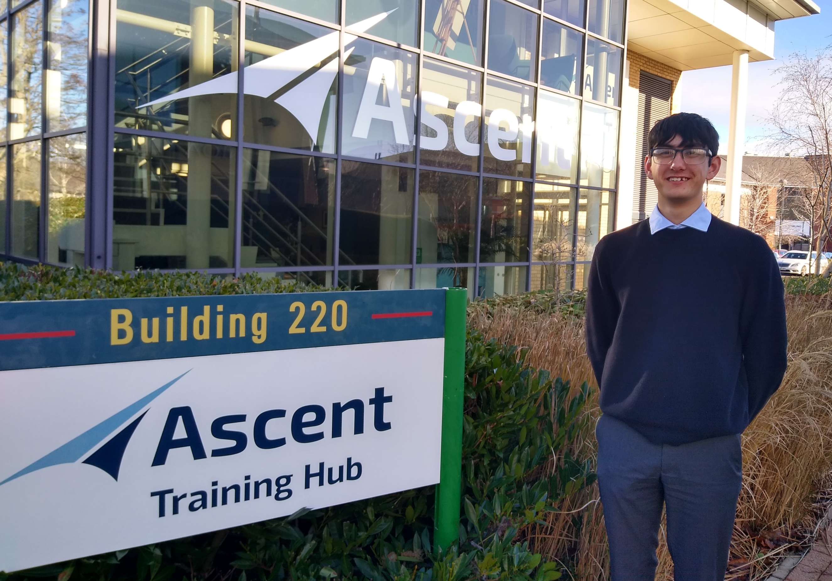 Aidan stood in front of the ascent flight training building and sign