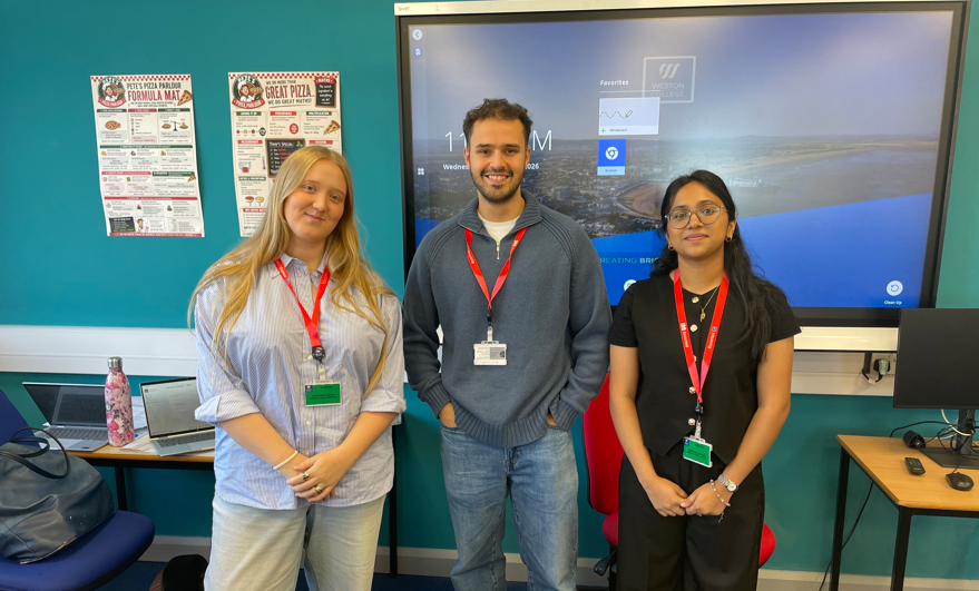EY Employees smiling at the front of the classroom