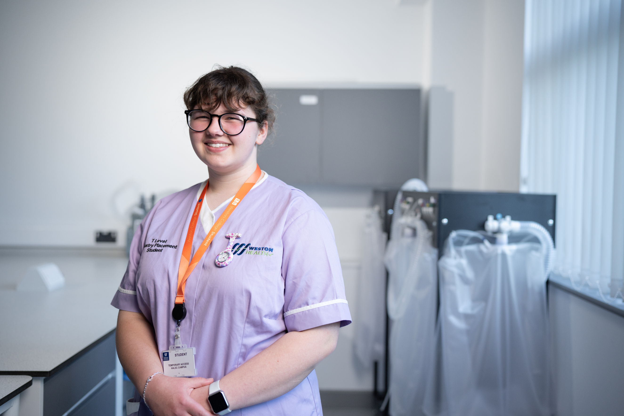 health student smiling in her scrubs