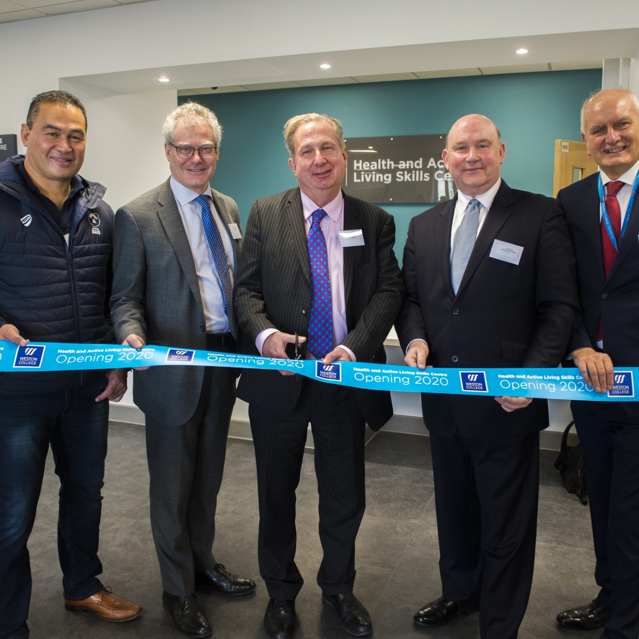 Dr Paul and guests cutting ribbon