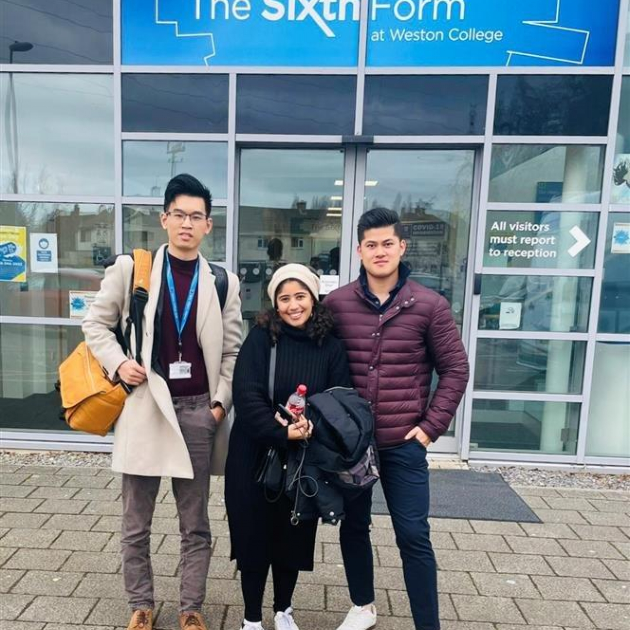 Lecturer Ethan Shi with Nour and Kenny stood outside Weston College's Sixth Form based at their Loxton Campus