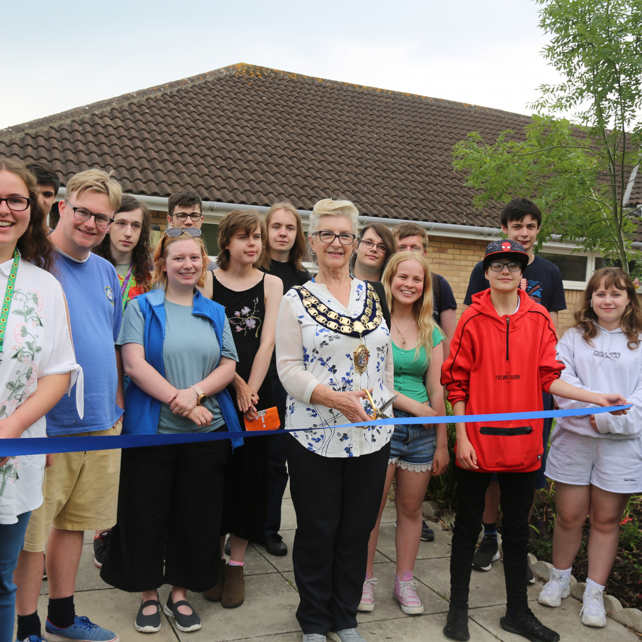 Group of college students stood with the Mayor or Weston-super-Mare as she cuts the ribbon