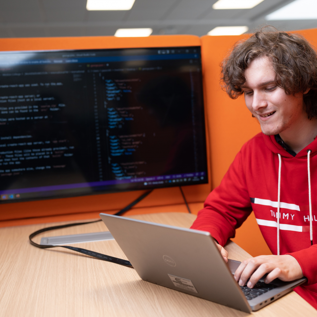 university student working on coding on laptop