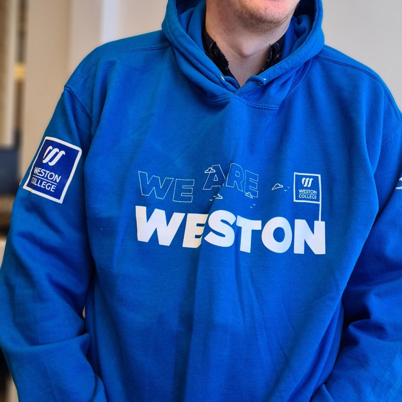student wearing blue weston college hoodie