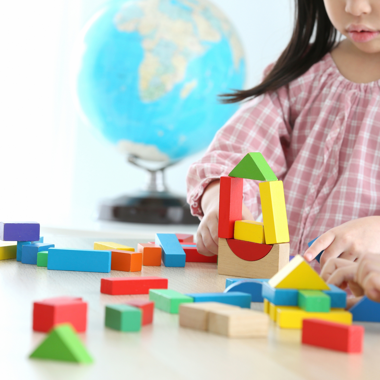 Preschool child playing with blocks