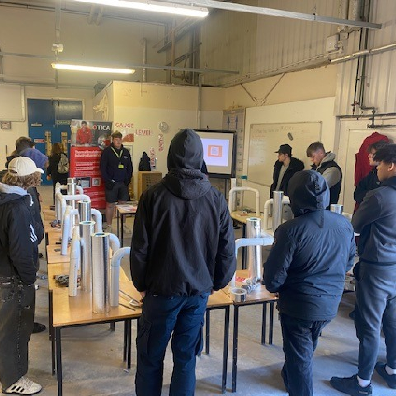Plastering learners listening to guest talk from Tica Acad