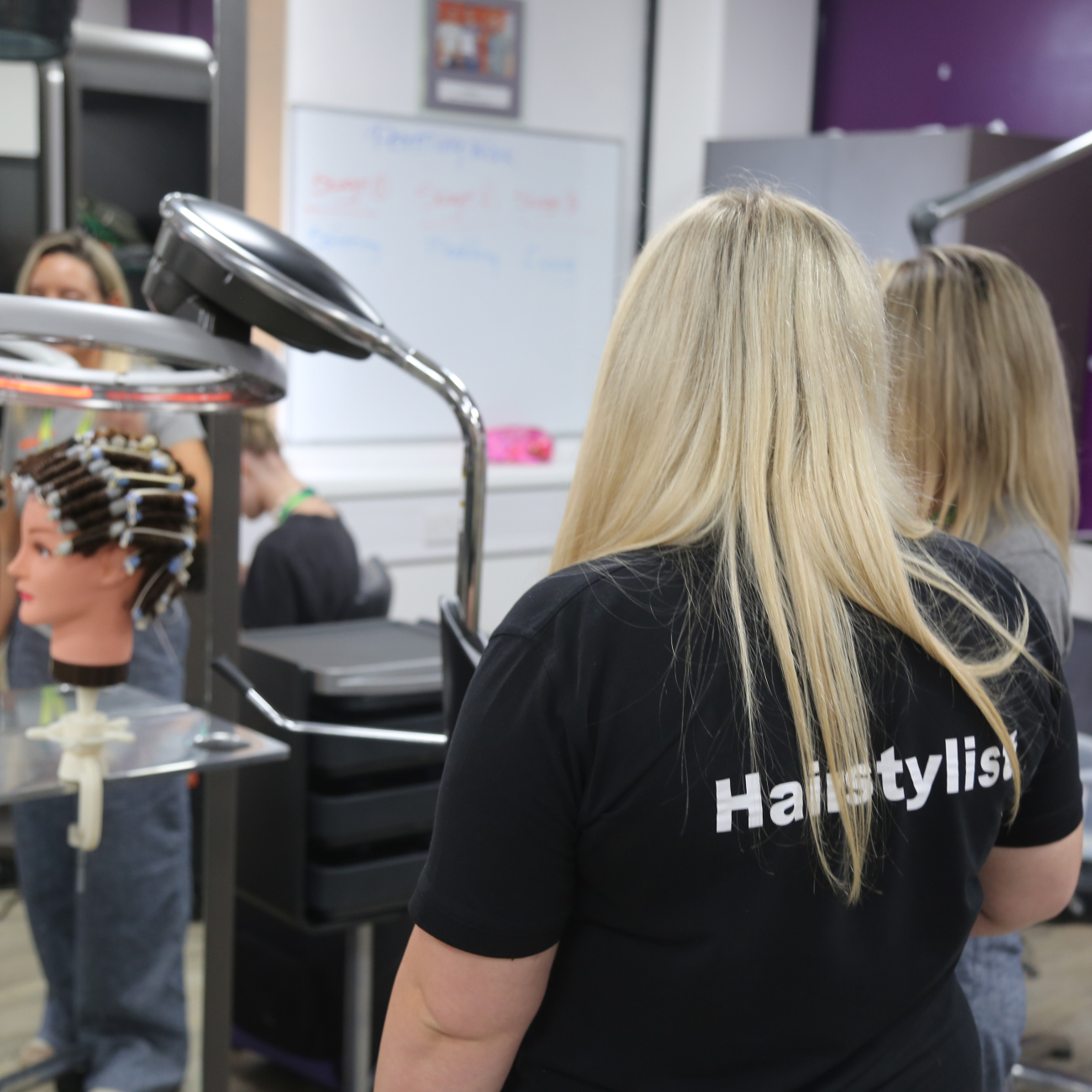 Hairdressing learner in demonstration 