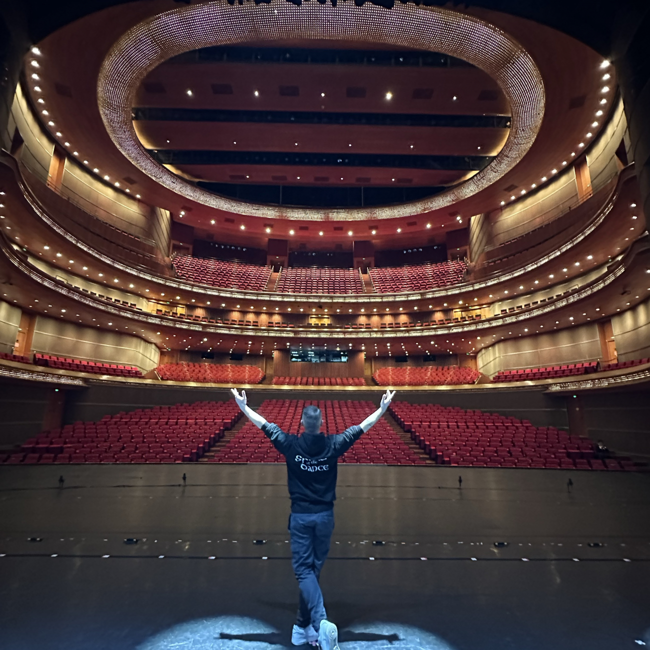 Joe, Weston College's performing arts lecturer, in Beijing, China on stage in empty theatre