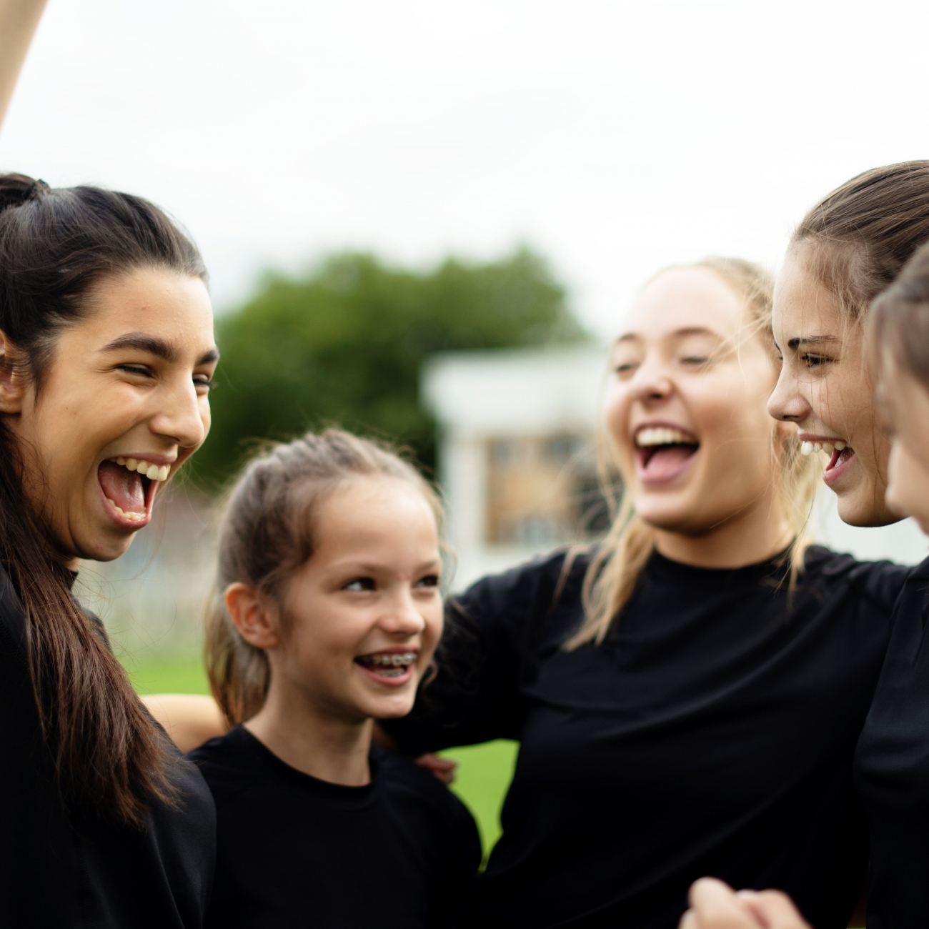 Cheerful female football players celebrating