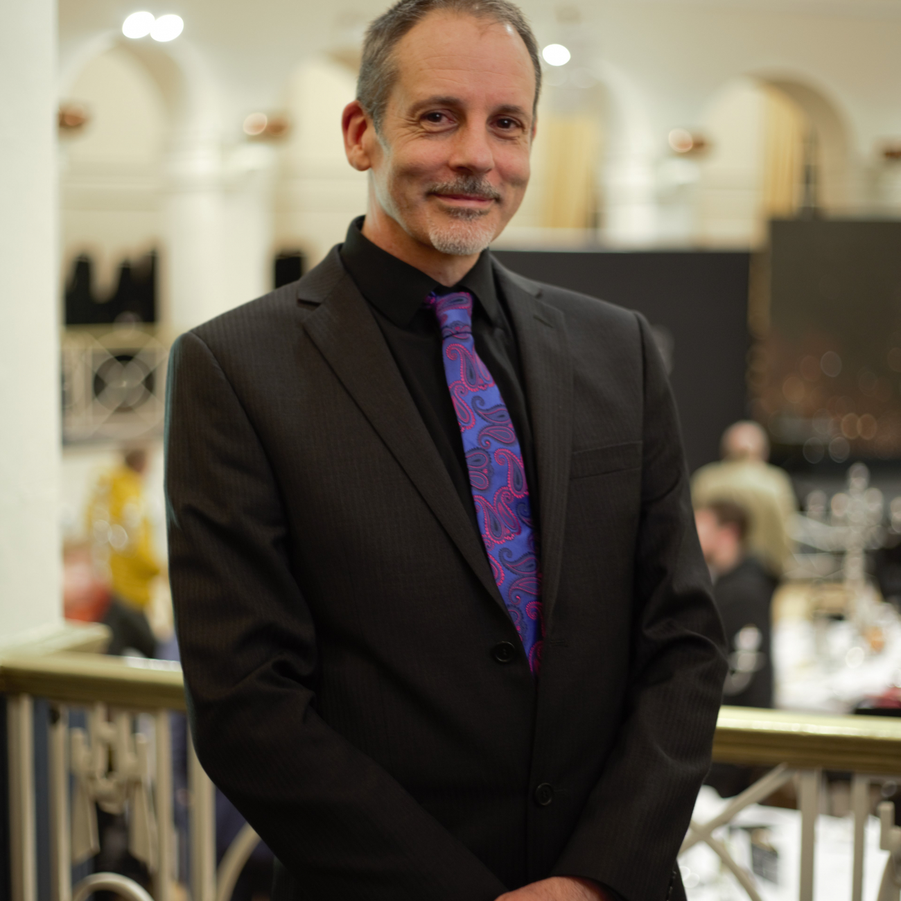 Paul French smiling at the camera at an event