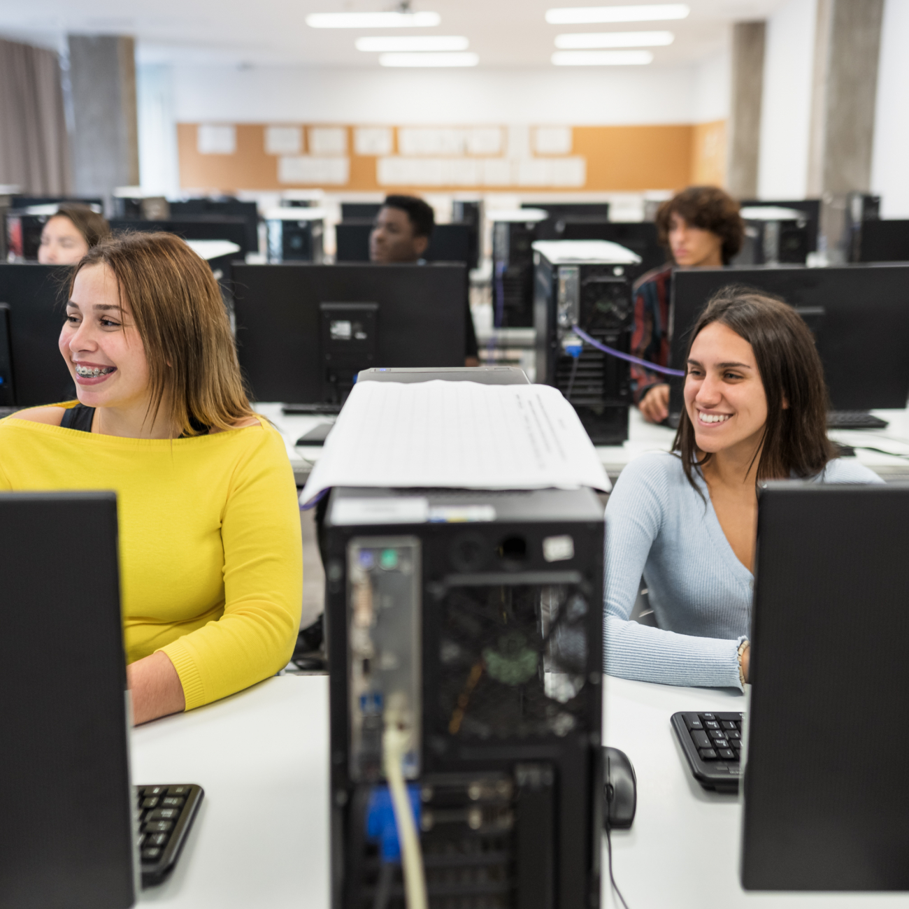 Learners sat smiling at their computers