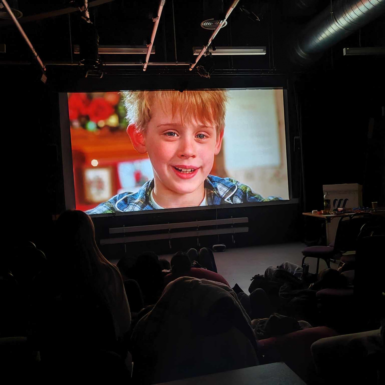 Students watching the film Home Alone on a projector