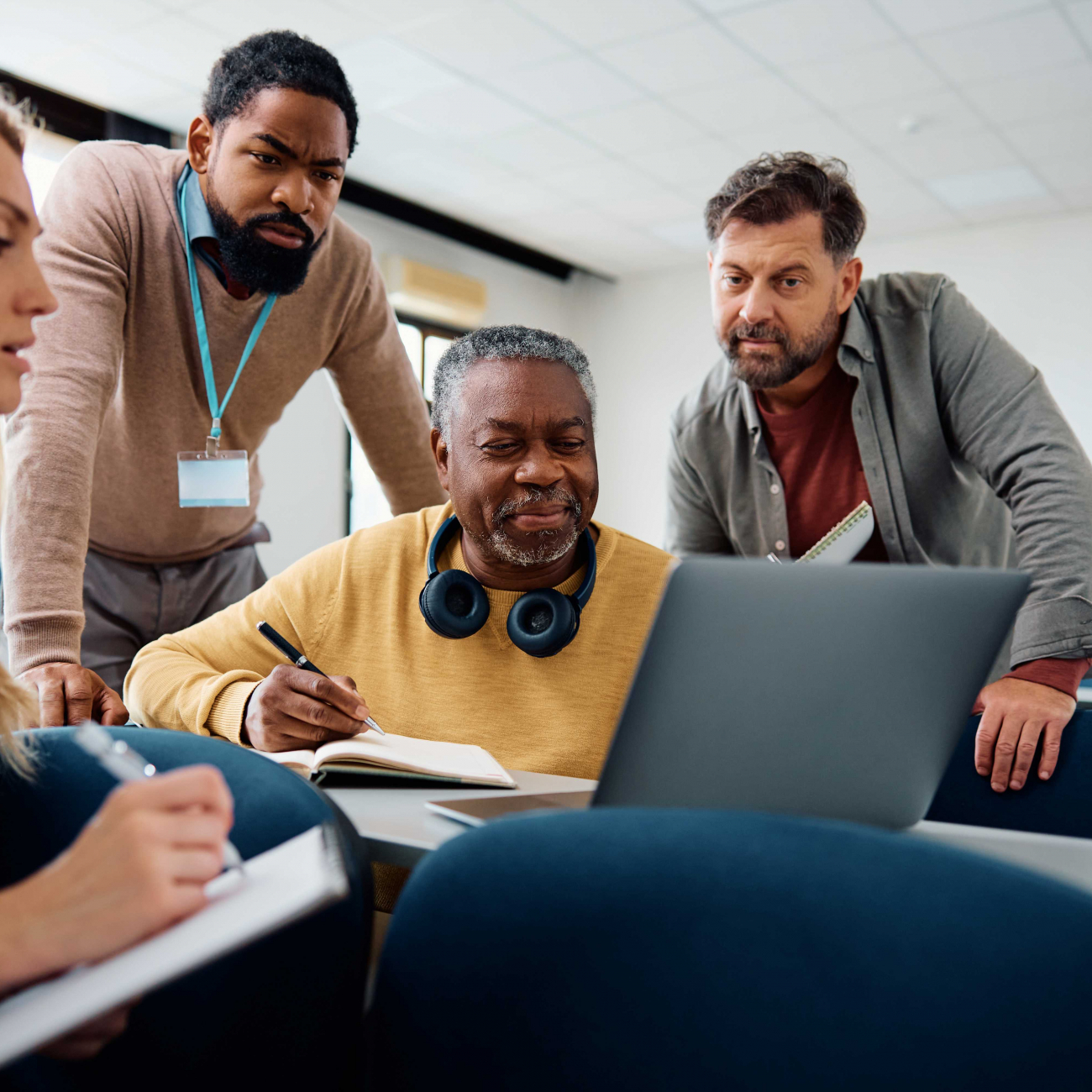 Adult learners working on a laptop