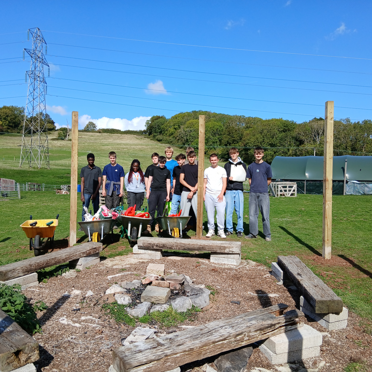 Construction group photo standing by the wooden posts they inserted