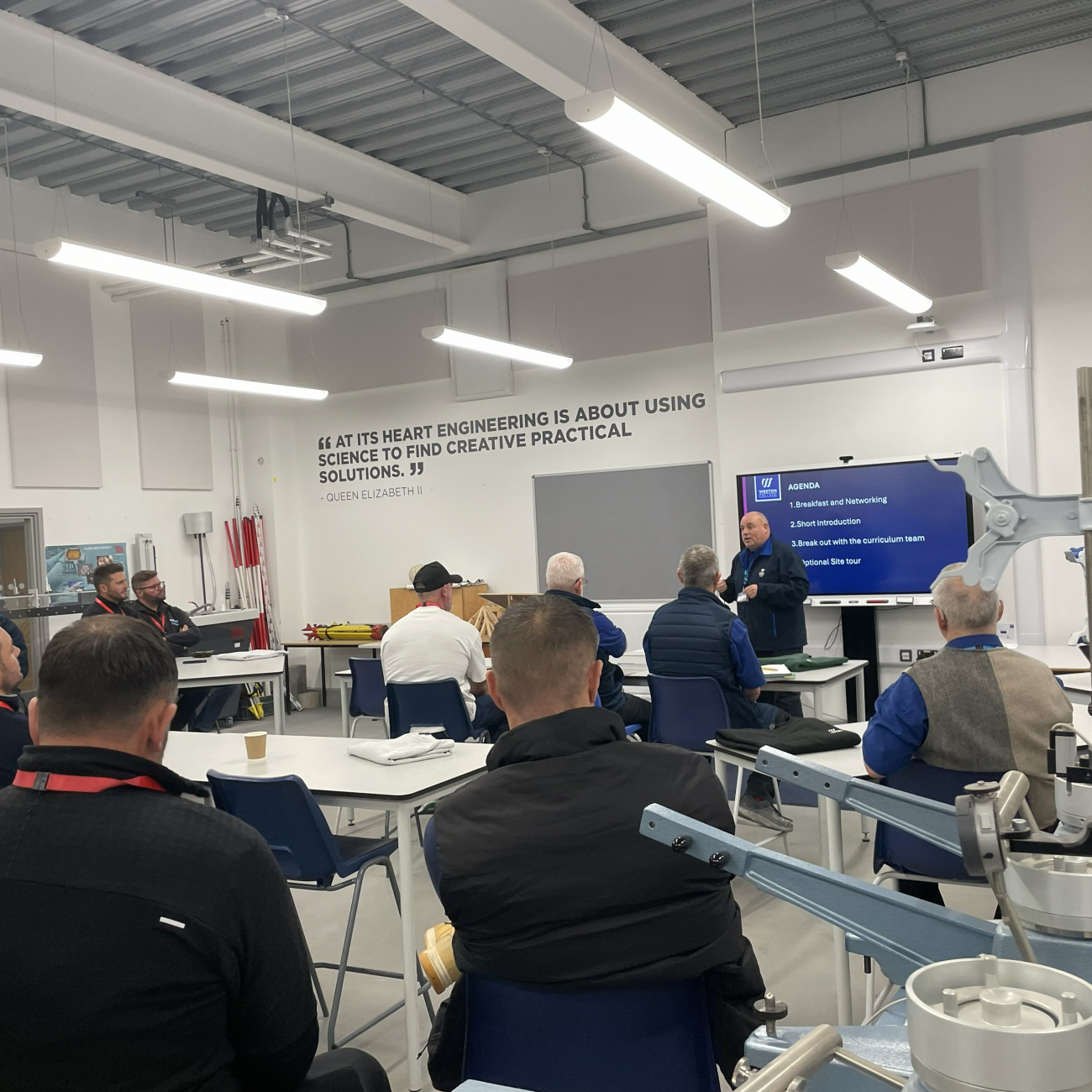 Employers watching presentation at construction breakfast