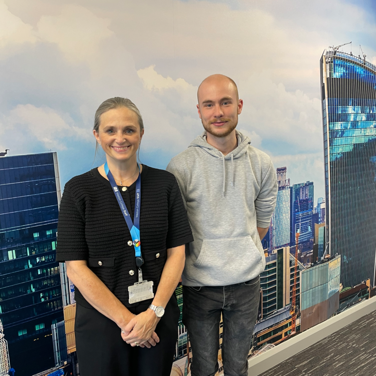 Ollie and ex-lecturer, Emma, standing together smiling