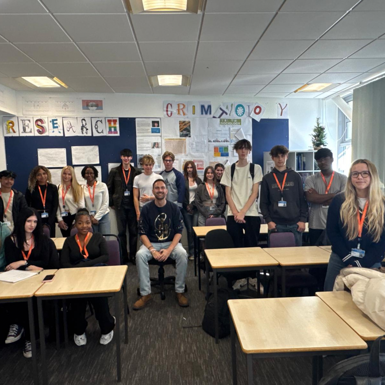 Dan Aldridge and Politics students smiling in classroom