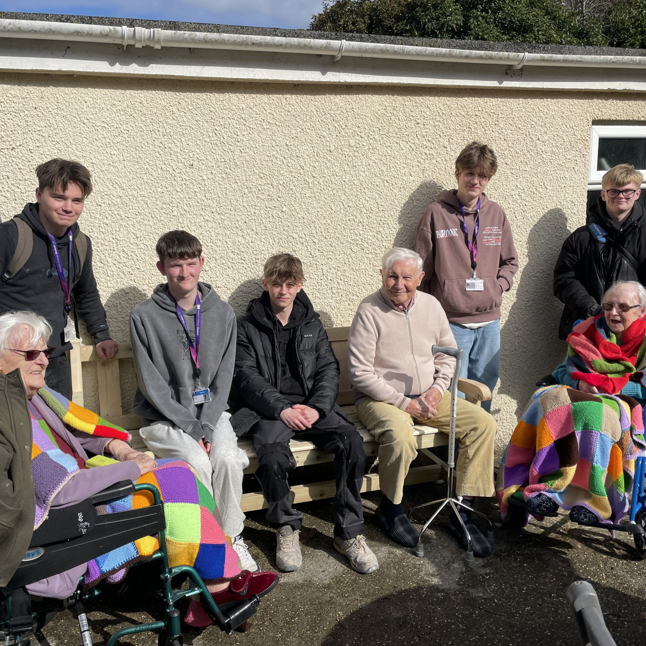 Students sitting with members of care home