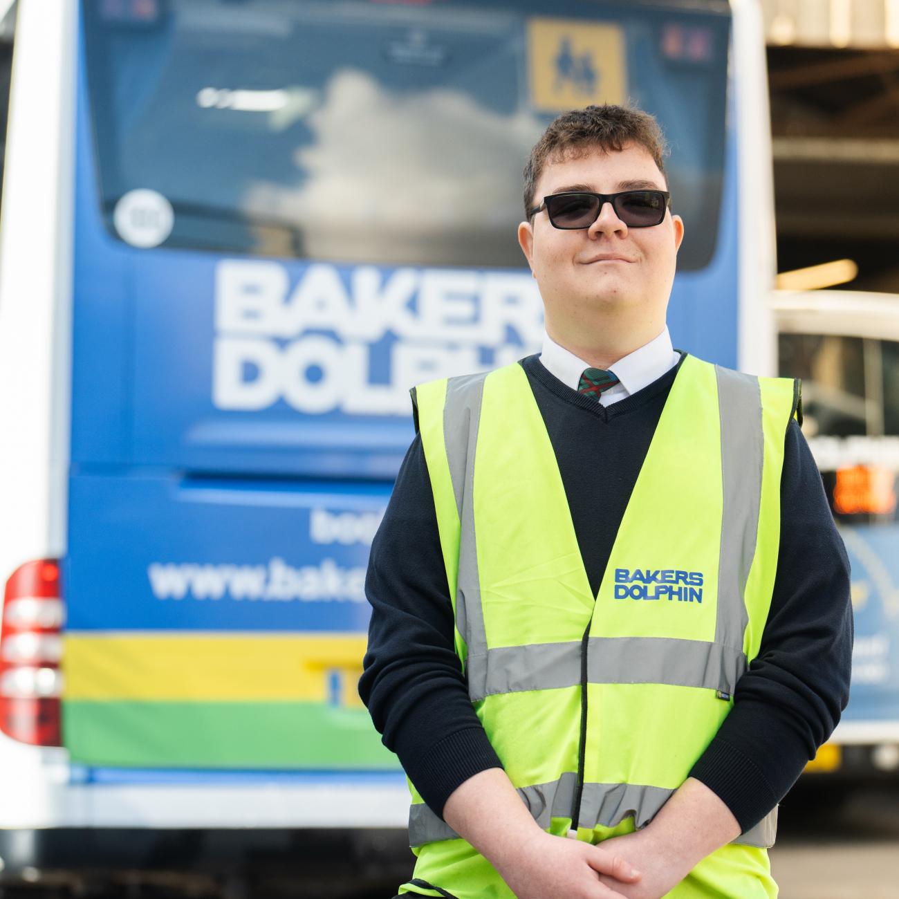 Harry Beasant smiling by Bakers Dolphin bus