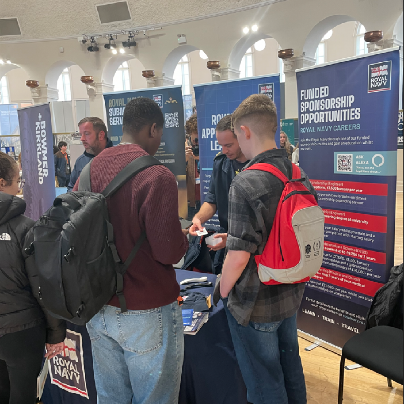 Two learners talking to the Royal Navy at CareersFest