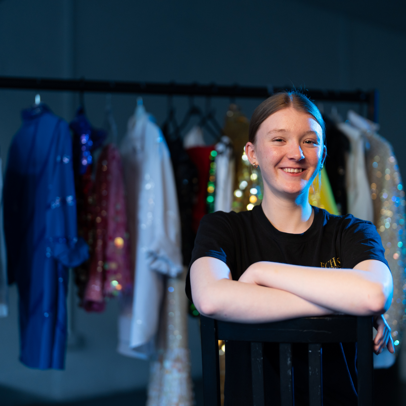 Performing Arts learner crossing her arms in front of wardrobe