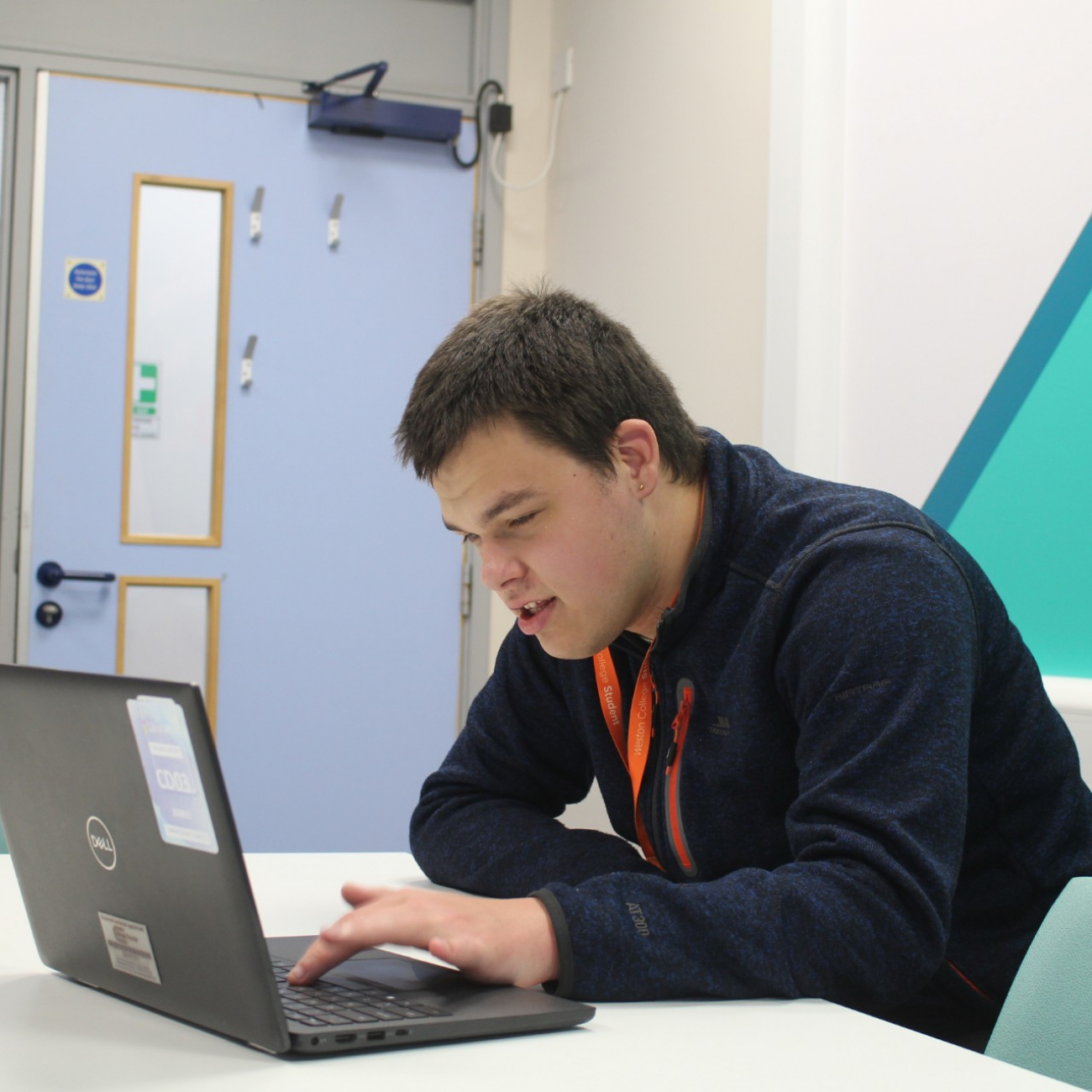 John working on a laptop