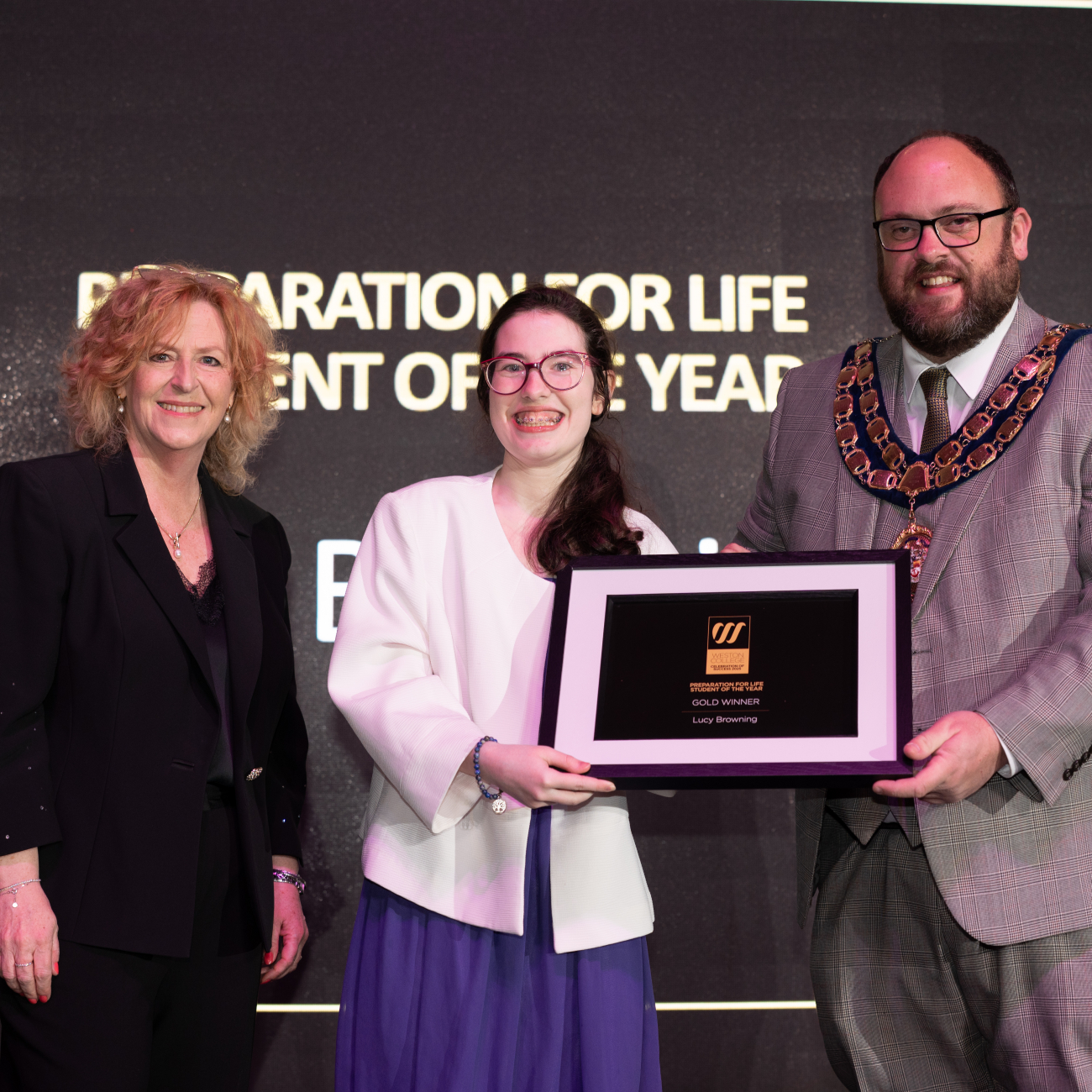 Lucy collecting her award from Principal Pat Jones and the Mayor