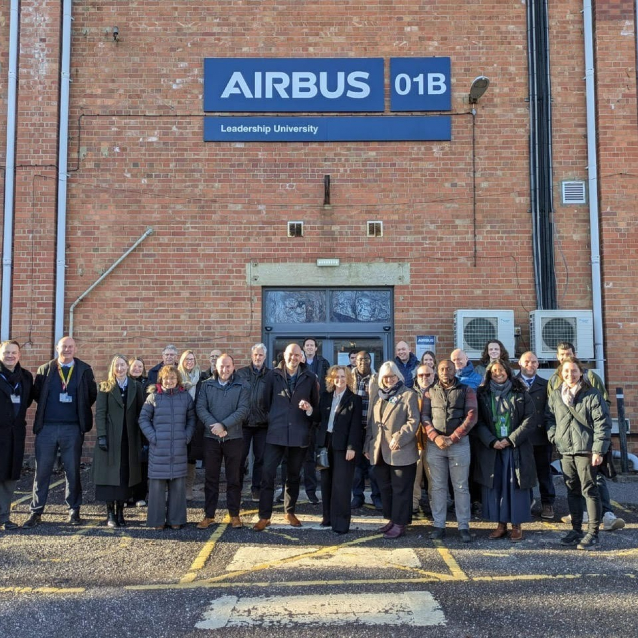 Group of Weston College and Airbus colleagues standing in front of Airbus building
