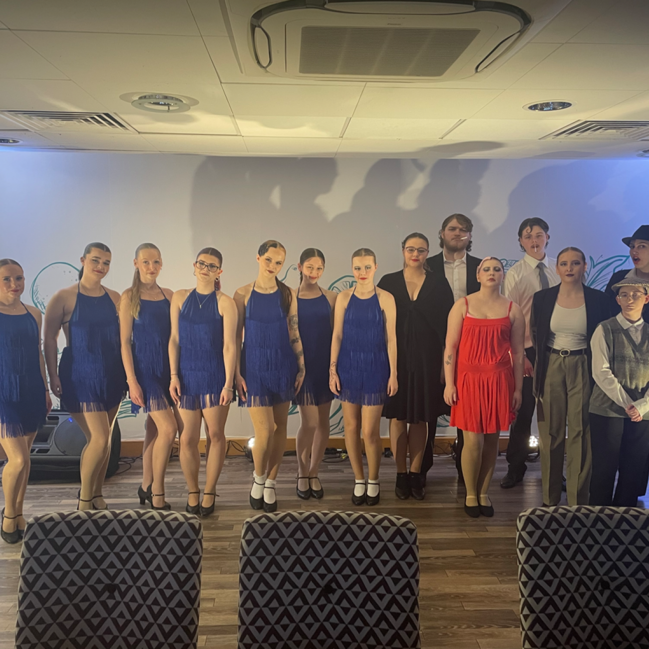 Students standing in a line smiling