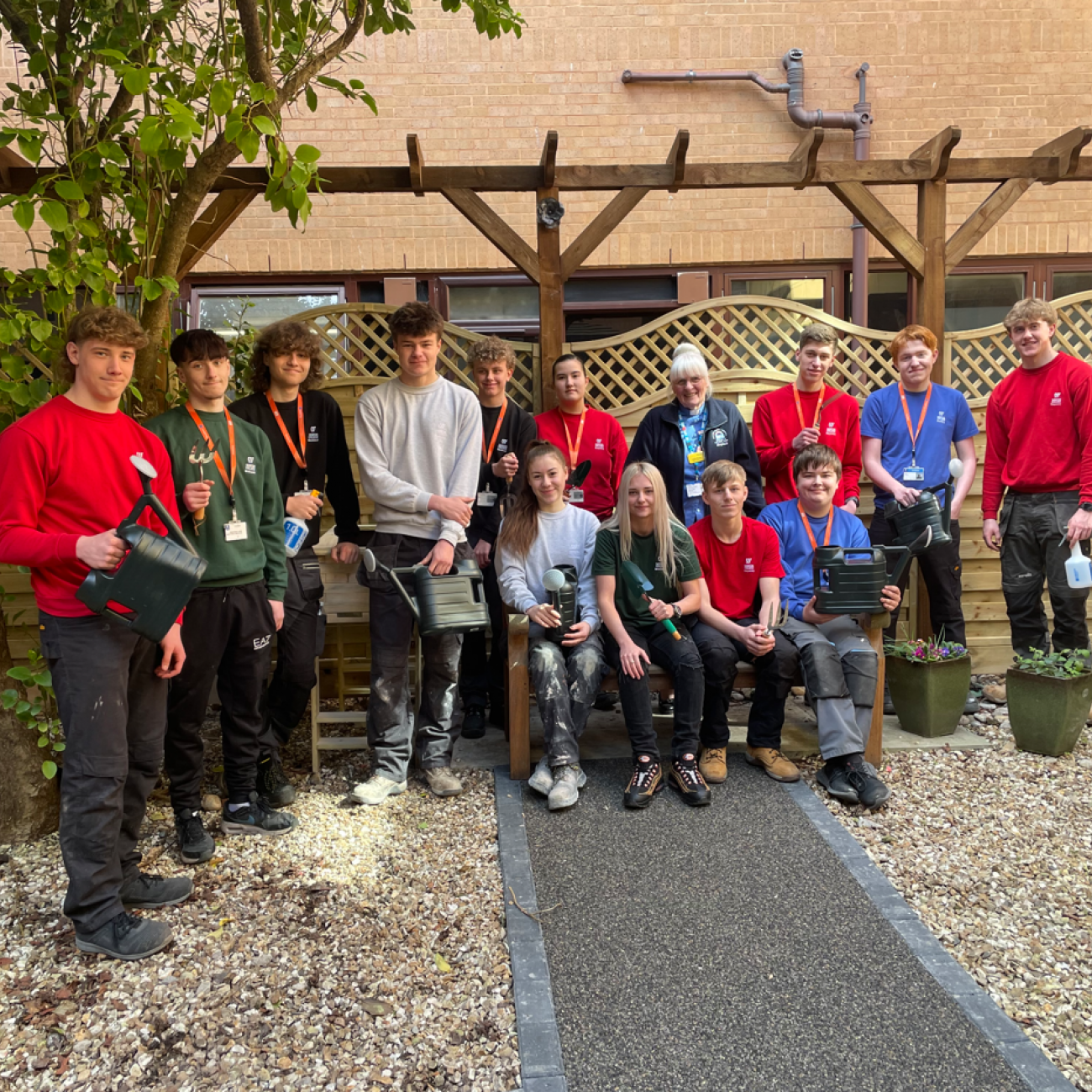 Construction students smiling in the Sanctuary Garden at Weston Hospital