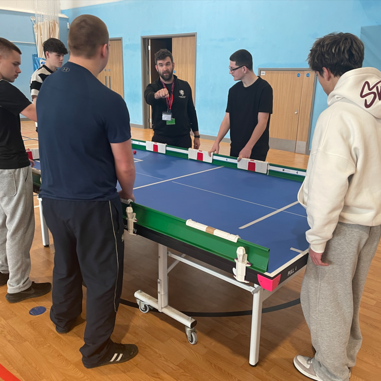 Students learning how to play table cricket