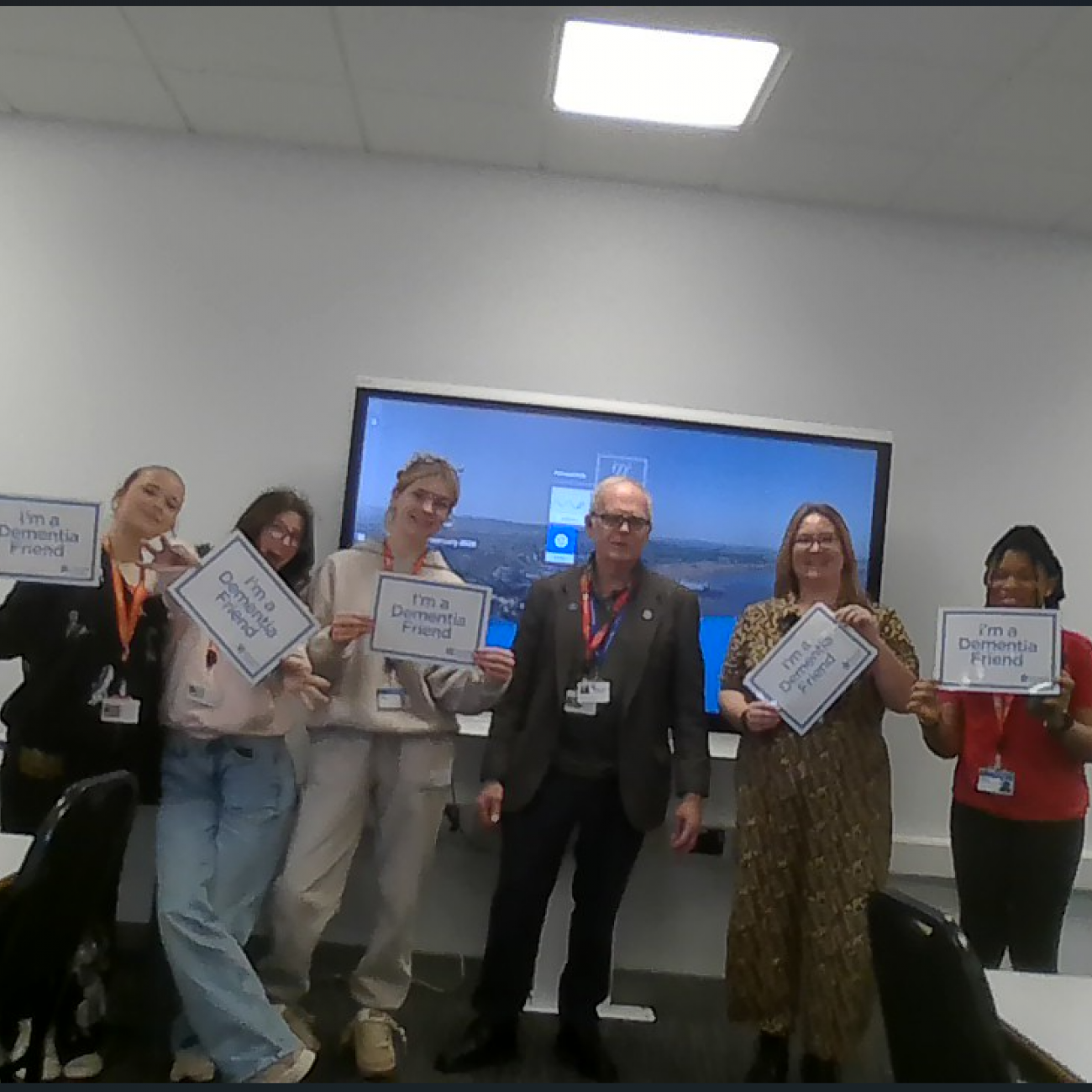 Students holding Dementia Friends signs