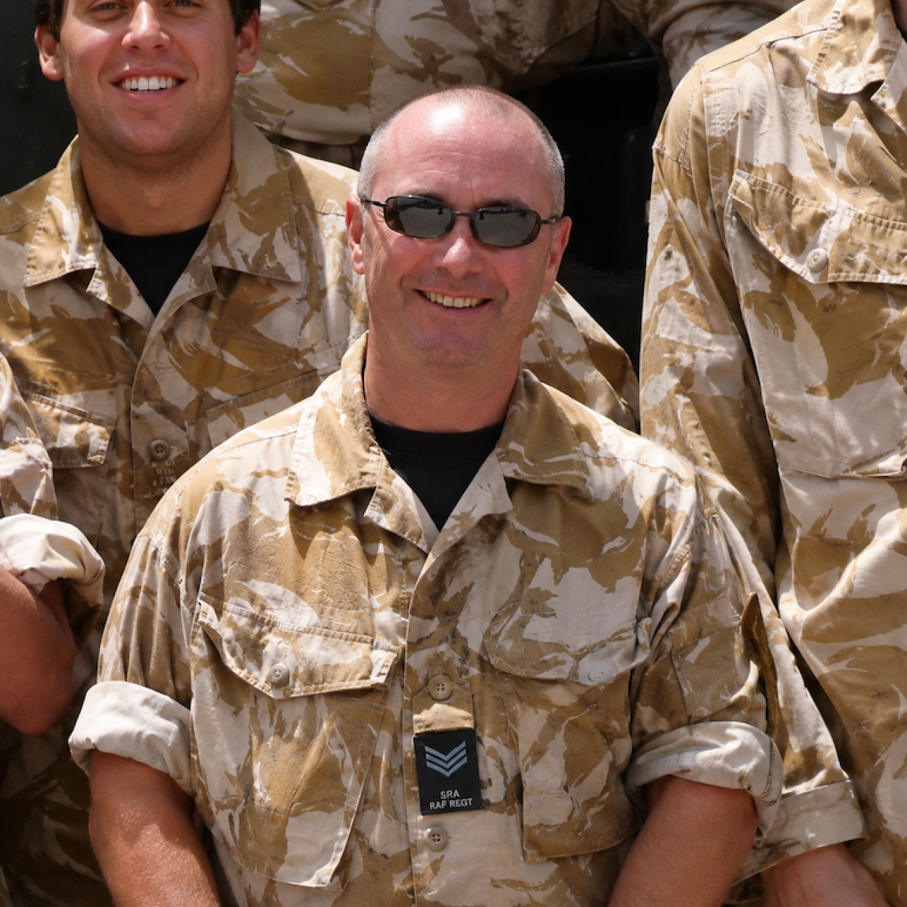 A picture of Neil in his RAF uniform. He is wearing glasses and smiling at the camera.
